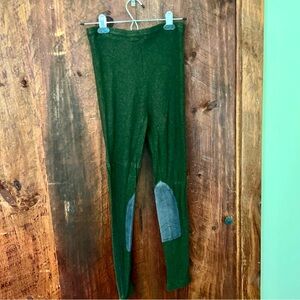 Women’s green equestrian riding leggings with knee patches.